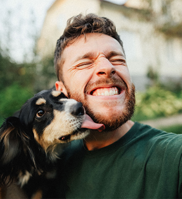 man smiling with dog