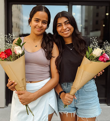 young women holding flowers