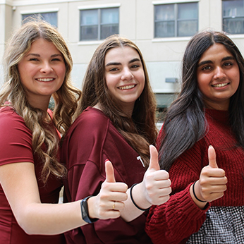 group of young women thumbs up